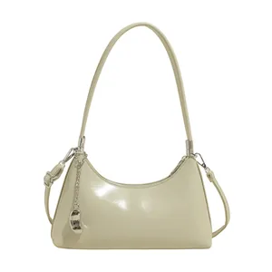 Chic cream-white patent leather hobo bag with adjustable strap and fashion charm