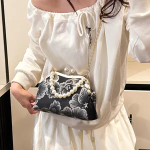 Ethnic embroidered bag with flower pattern, pearl clasp, and golden chain strap