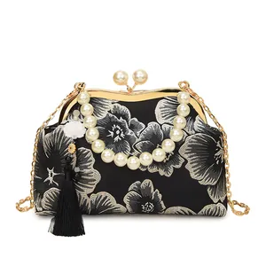 Vintage black embroidered handbag with silver flower patterns and pearl handle strap
