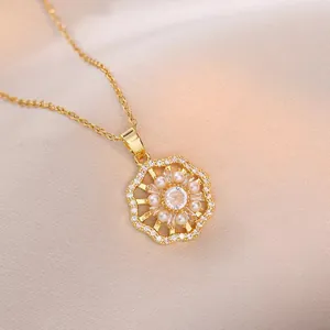 Elegant gold flower necklace with rotating zircon pendant and pearls on silk background