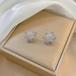 Elegant silver snowflake stud earrings featuring sparkling cubic zirconia stones