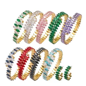 Set of nine colorful C-shaped hoop earrings with marquise-cut crystal studs on gold metal