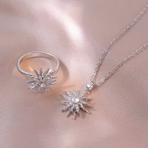 Rotating floral pendant necklace and ring set with sparkling zircons in silver finish