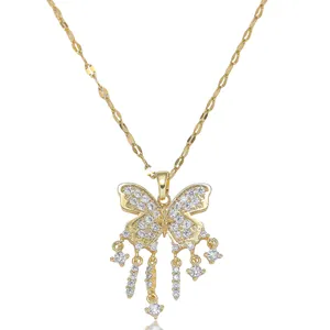 Detailed close-up of golden butterfly pendant with sparkling cubic zirconia and tassels