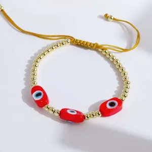 Detailed shot of handmade adjustable evil eye bracelet with 18K gold plated copper beads