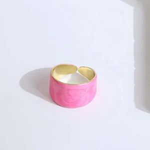 Detail of pink marble enamel wide open ring with polished gold edges and adjustable band