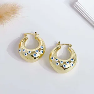 Macro detail of 18K gold plated chunky hoop earrings featuring colorful evil eye motifs
