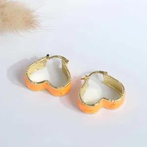 Detail of 18K gold-plated heart earrings with orange enamel and S925 hallmark