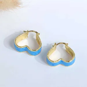 Detailed close-up showing the S925 hallmark on blue marbled enamel heart hoop earrings