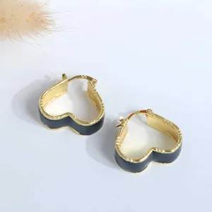 Detail of 18K gold plated heart hoop earrings with black enamel and S925 silver needles