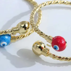 18K gold plated twisted rope evil eye open cuff bracelet with blue enamel details