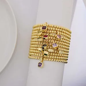 Stack of 18k gold plated beaded bracelets with colorful square zircon birthstone charms
