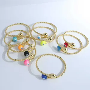 Detailed close-up of 18K gold-plated twisted rope bracelets with colorful evil eye beads