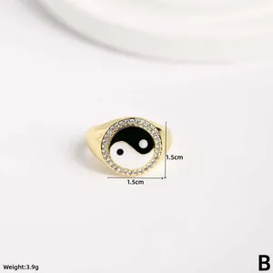 Detail of gold yin yang ring with shell inlay and cubic zirconia stones 1.5cm wide