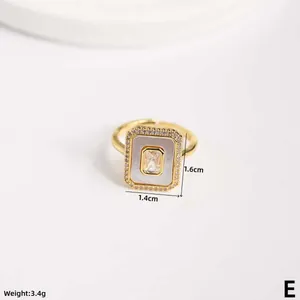 Detail of gold rectangular ring with shell inlay and cubic zirconia stones, size 1.4x1.6cm