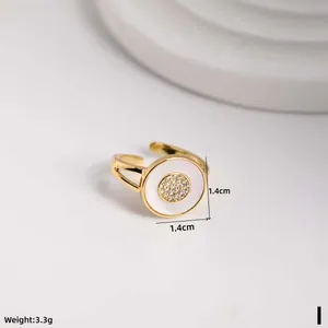 Detailed view of adjustable golden shell ring with zircon inlay and size measurements