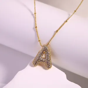 Close-up of 18K gold-plated necklace featuring a micro-pave zircon letter A pendant