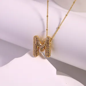 Detailed macro view of the gold-plated letter M pendant featuring pavé-set cubic zirconia