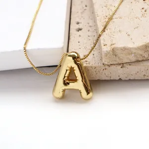 Detail of 3D bubble style letter A pendant with mirror polished gold finish and box chain