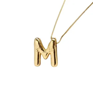 Polished gold M letter pendant necklace with engraved starburst patterns and box chain