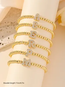 Detail of 17cm gold beaded bracelets with sparkling zirconia bubble letter pendants