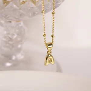 Detailed macro of 18K gold plated bubble letter A pendant on a beaded twist chain