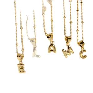 Polished gold bubble letter pendants E, L, A, M, C on beaded chain necklaces for women
