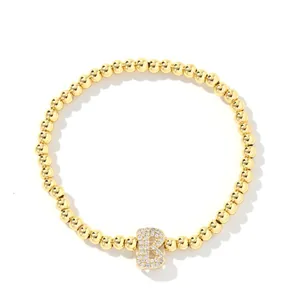 Gold beaded bracelet with sparkling zircon-encrusted letter B pendant in balloon style