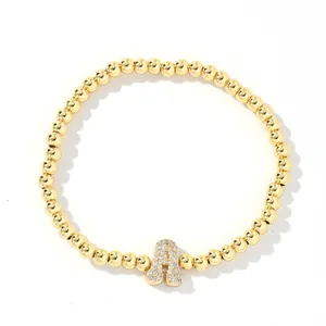 Polished gold beaded bracelet with a crystal-encrusted balloon letter A charm