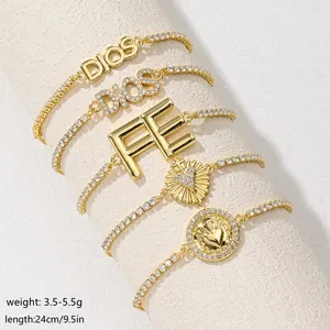 Close-up of 18K gold-plated tennis bracelets with sparkling zircon and religious charms