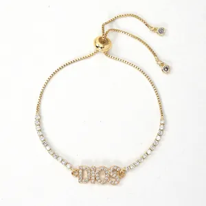 Macro detail of adjustable gold plated heart letter bracelet with cubic zirconia inlays