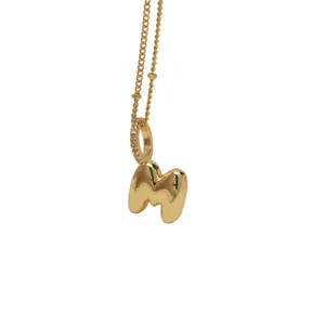 Golden 18K gold-plated bubble letter M pendant necklace with sparkling rhinestone bail