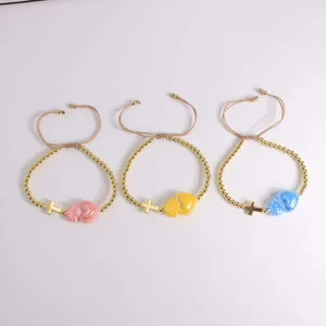 Three-piece 18K gold beaded bracelet set with religious cross and heart charms