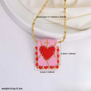 Detail of 18K gold woven pendant with heart and cross showing size 3.2x2.6cm and weight 8.6g