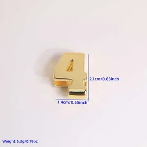 Macro detail of 18K gold plated number 4 charm with dimensions 2.1cm height and 5.3g weight
