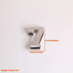 Detail view of a 3D number 7 charm in polished 18K gold-plated copper with size dimensions