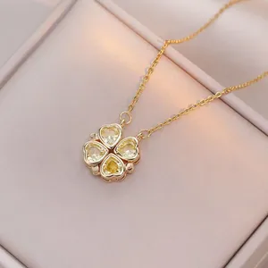 Golden necklace with a four-leaf clover pendant made of four yellow heart-shaped gems