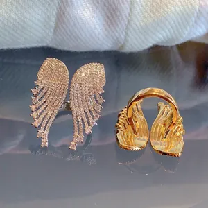 Macro detail of rose gold angel wing ring with pavé-set zircons and polished back