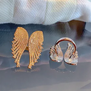 Micro pavé angel wing rings in gold and silver finish with sparkling zircon stones
