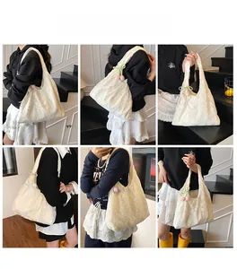 Detailed close-up of white lace tote bag with floral charm and intricate hollow patterns