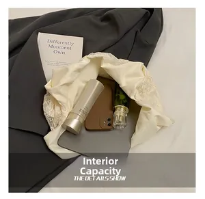 Flat lay detail showing internal capacity for tablet, phone and cosmetics in lace bag