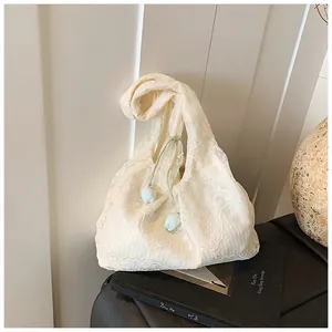 Close-up of white floral lace tote bag with light green ties and blue tulip ornaments