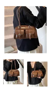 Close-up of vintage brown shoulder bag with silver buckles and large capacity pocket details