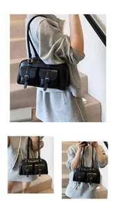 Detailed view of a black vintage hobo bag with double front flap pockets and silver buckles