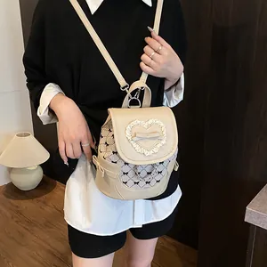 Beige mini backpack for women featuring lace heart trim and a bow on stylish PU leather