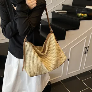 Retro straw tote bag with brown leather straps and zipper closure for beach vacations