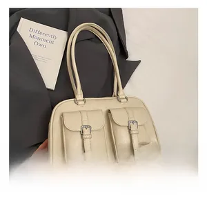 Close-up of cream PU leather underarm bag featuring double front flap pockets with buckles