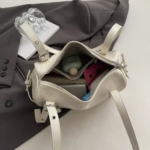 Chic cream pillow bag with organized interior compartments and silver hardware accents