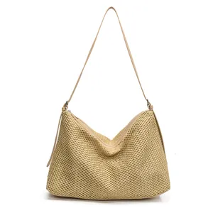 Large woven hobo tote bag with straw texture and faux leather straps for beach travel