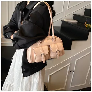Detail of pink-beige Boston bag with double front flap pockets and adjustable top handles